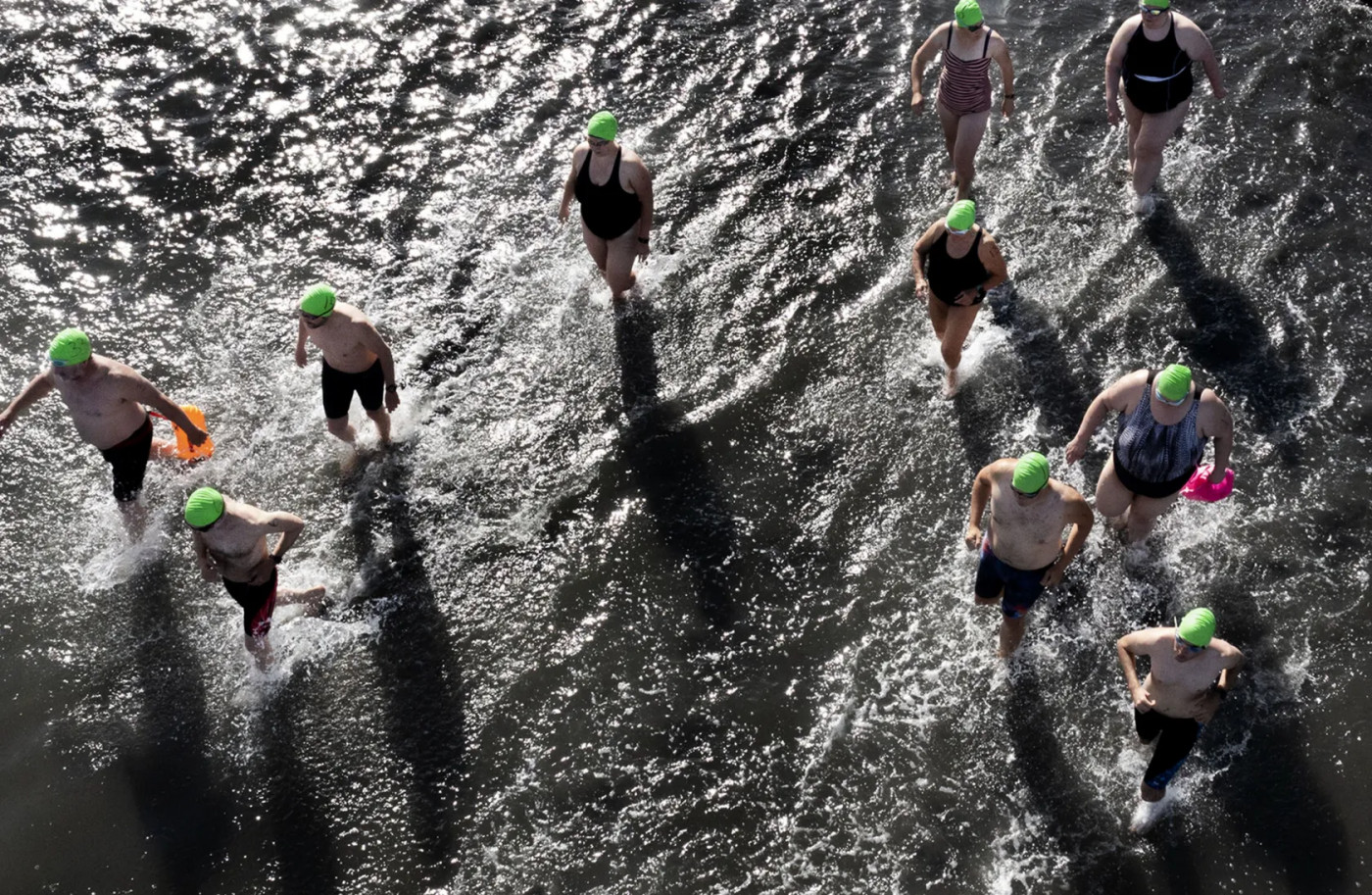 Swimmers run to deeper water during the 1-mile open swim competition at Great Salt Lake State Park in Magna on Saturday, June 11, 2022.Laura Seitz, Deseret News